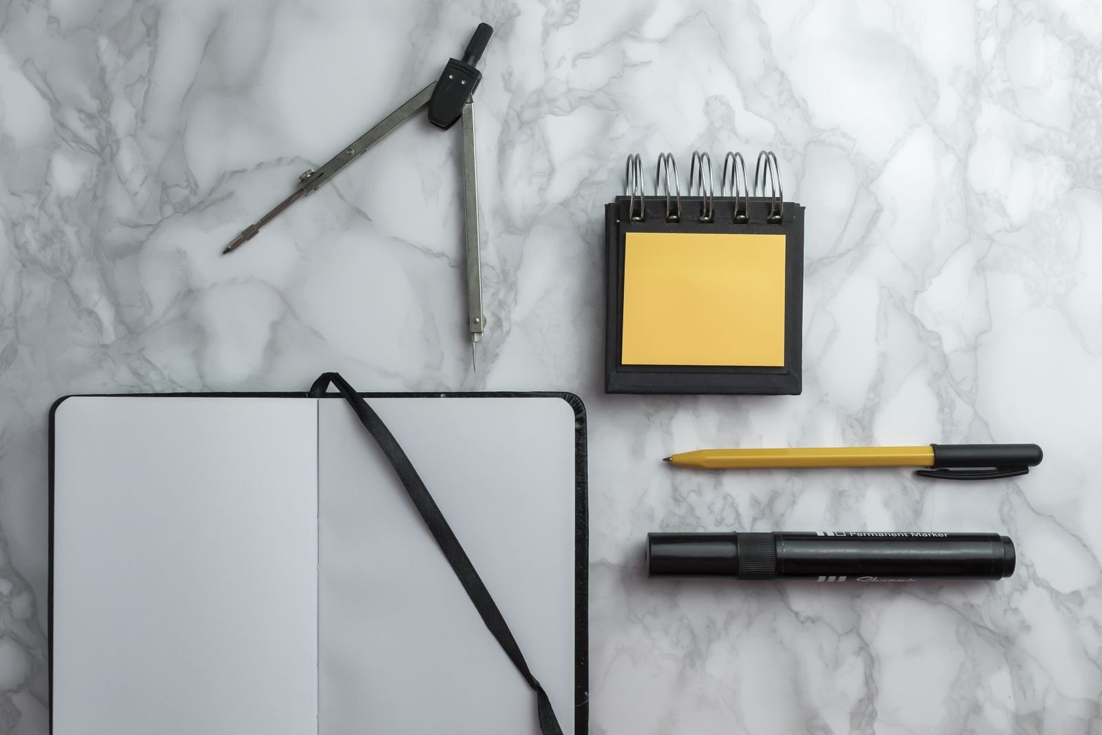 Notebook and pen on marble surface