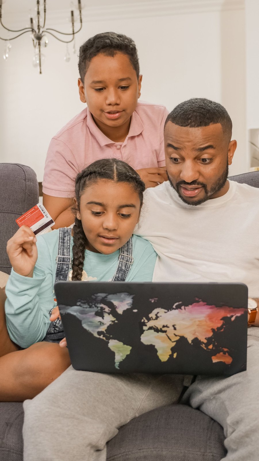 Photograph of a family looking at a laptop screen