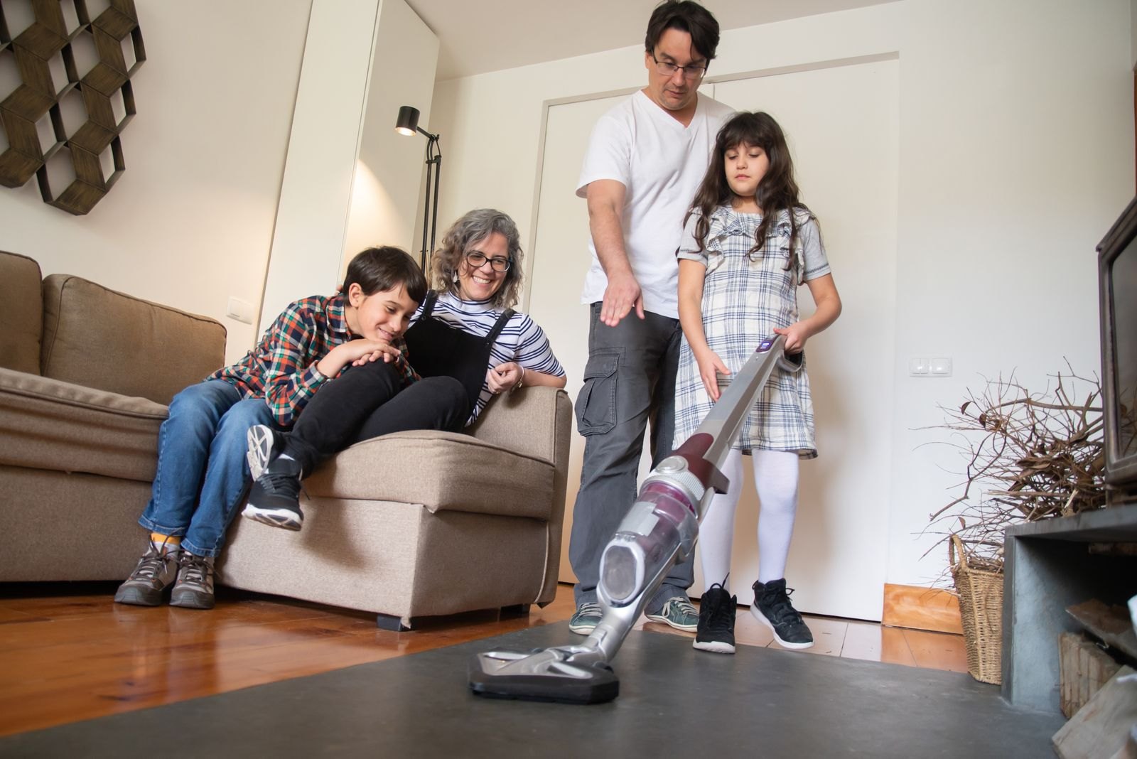 Family vacuuming in a living room