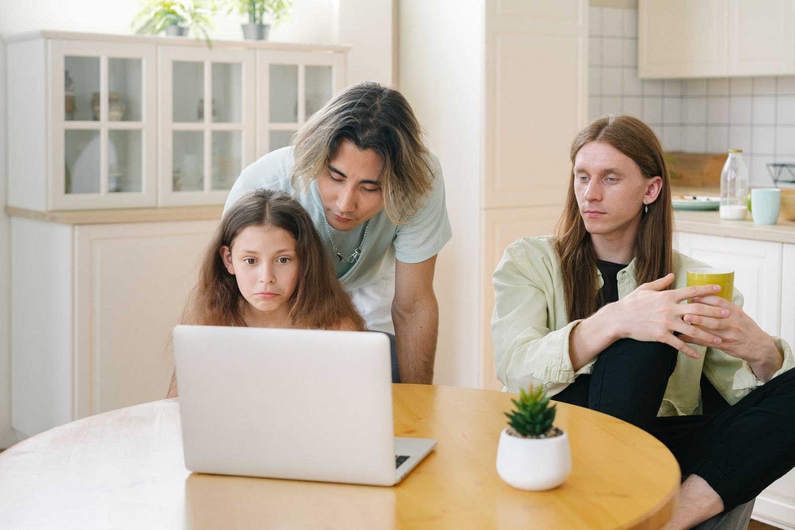 A happy family looking at the screen of a laptop