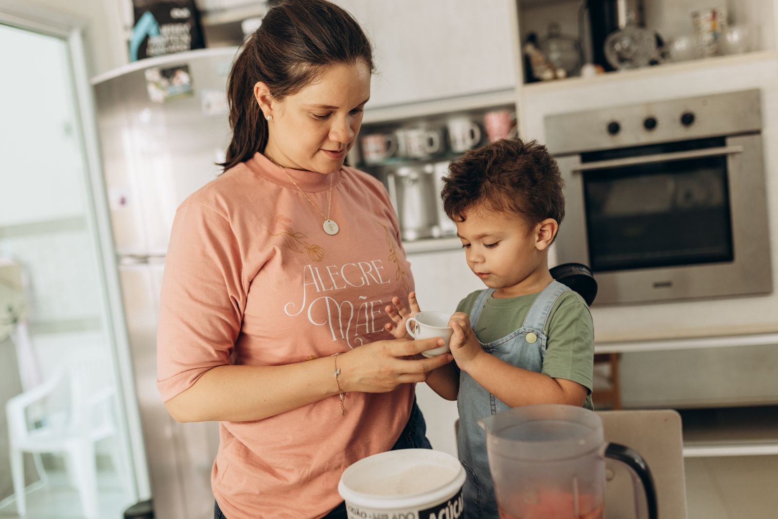 Mother and son holding cup