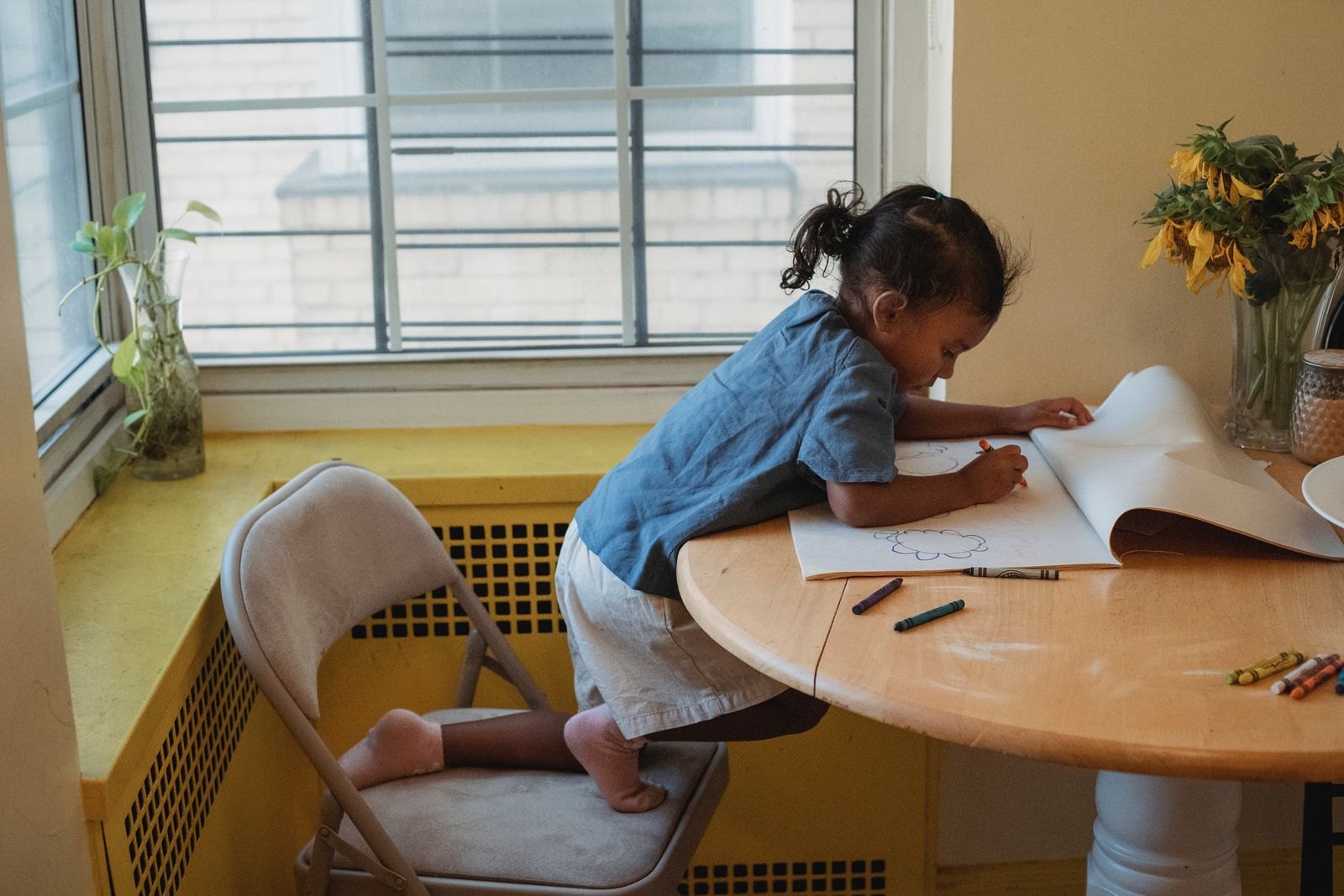Child drawing at a table