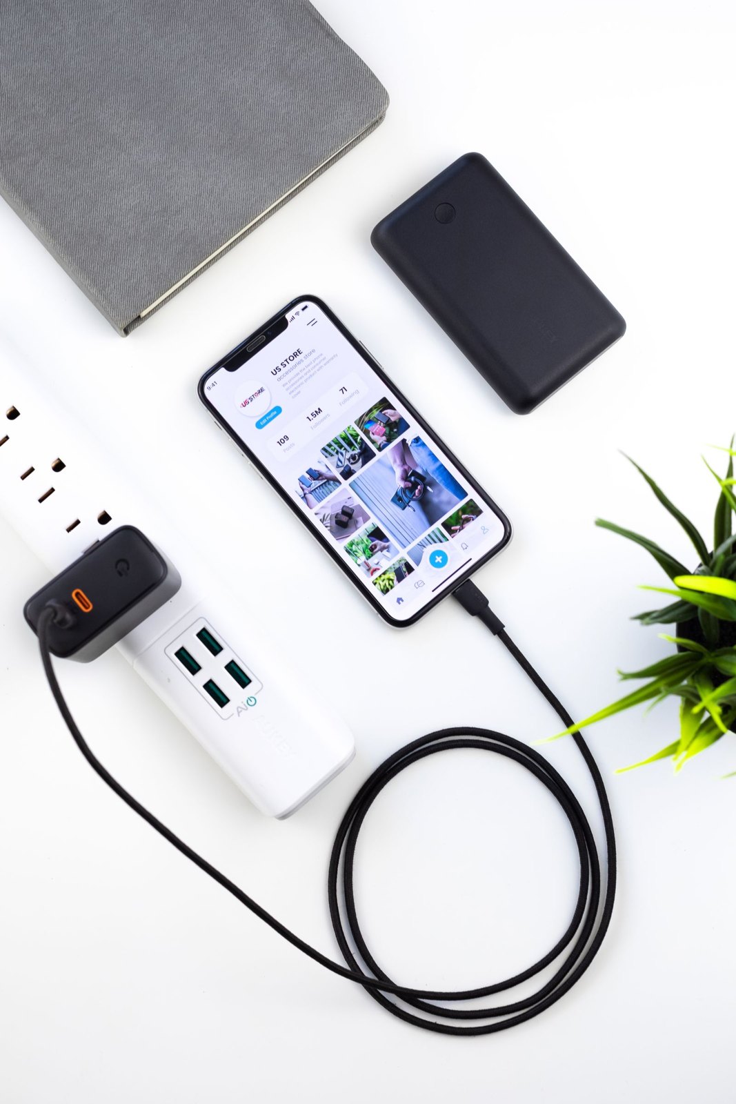 Smartphone charging on a desk beside a tablet