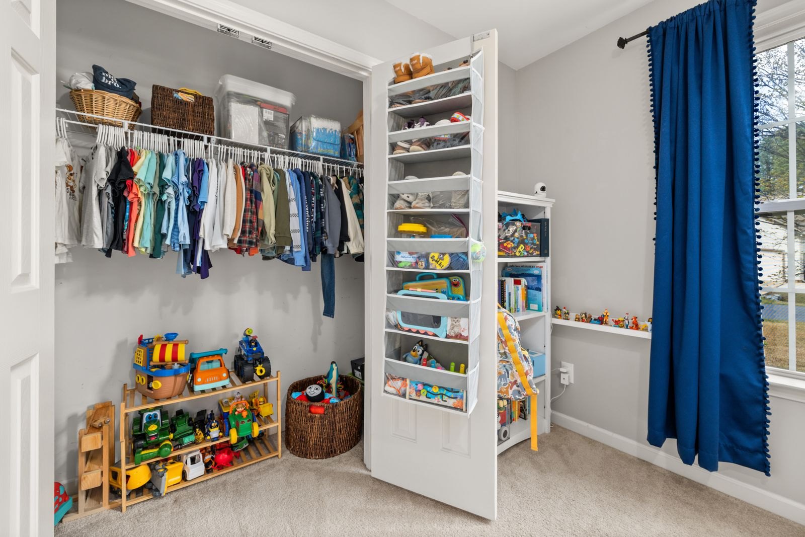Organized children s closet with toys and clothes