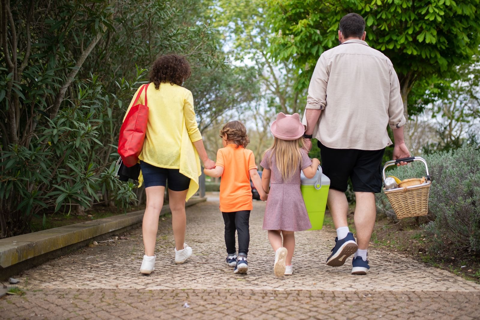 Back view of a family walking together in the park