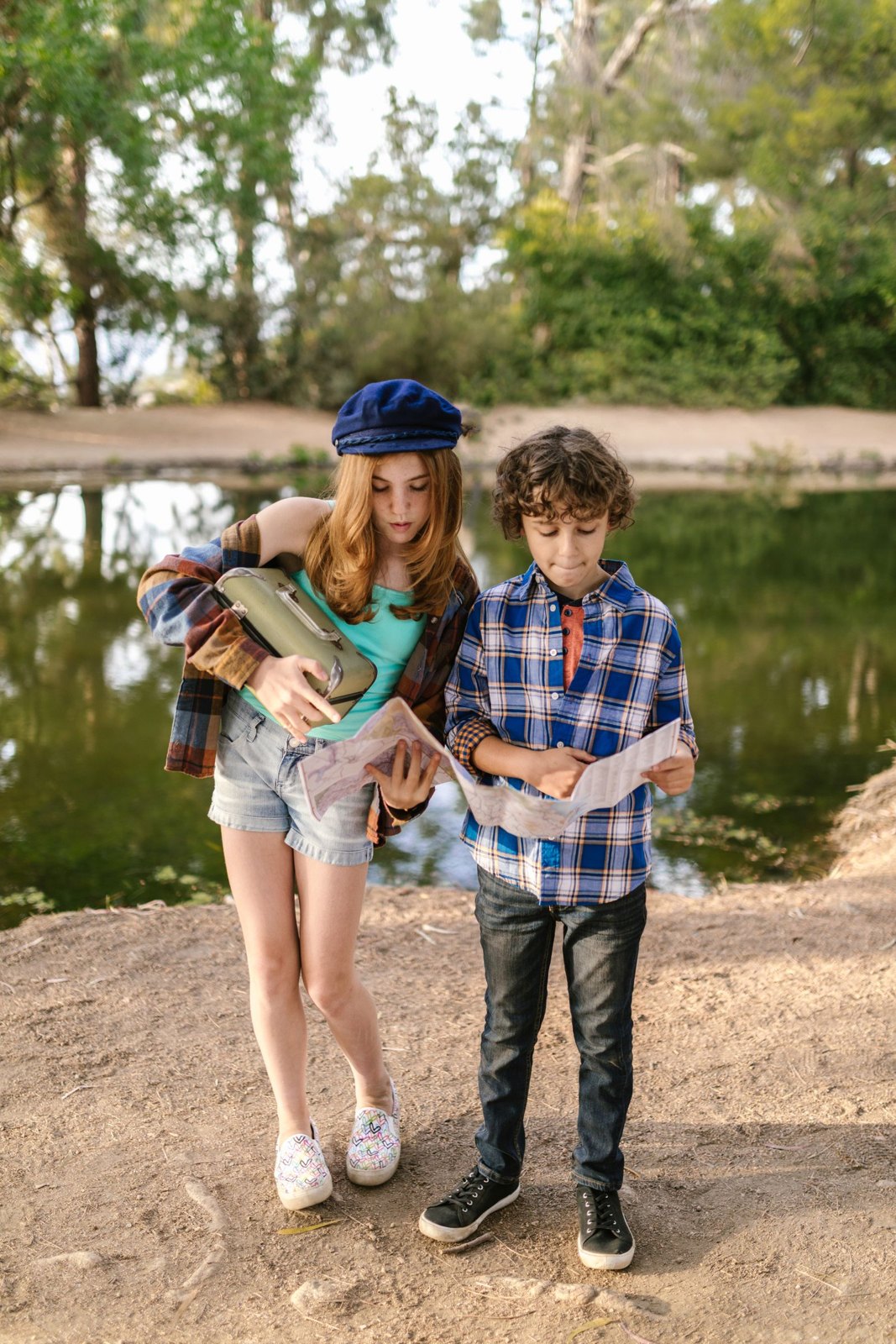 Children looking at a map by the lake